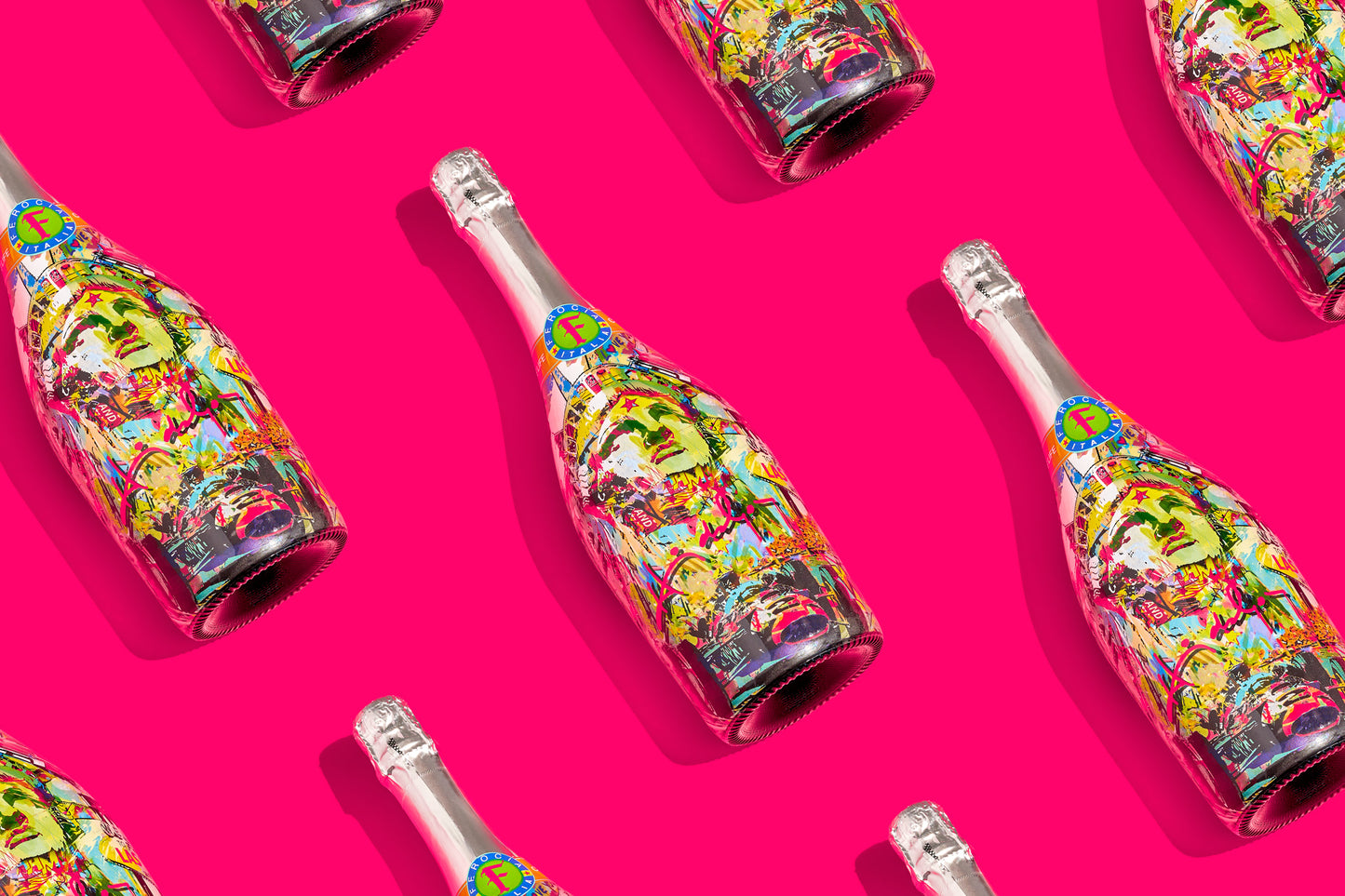 Colorful champagne bottles on a pink background.