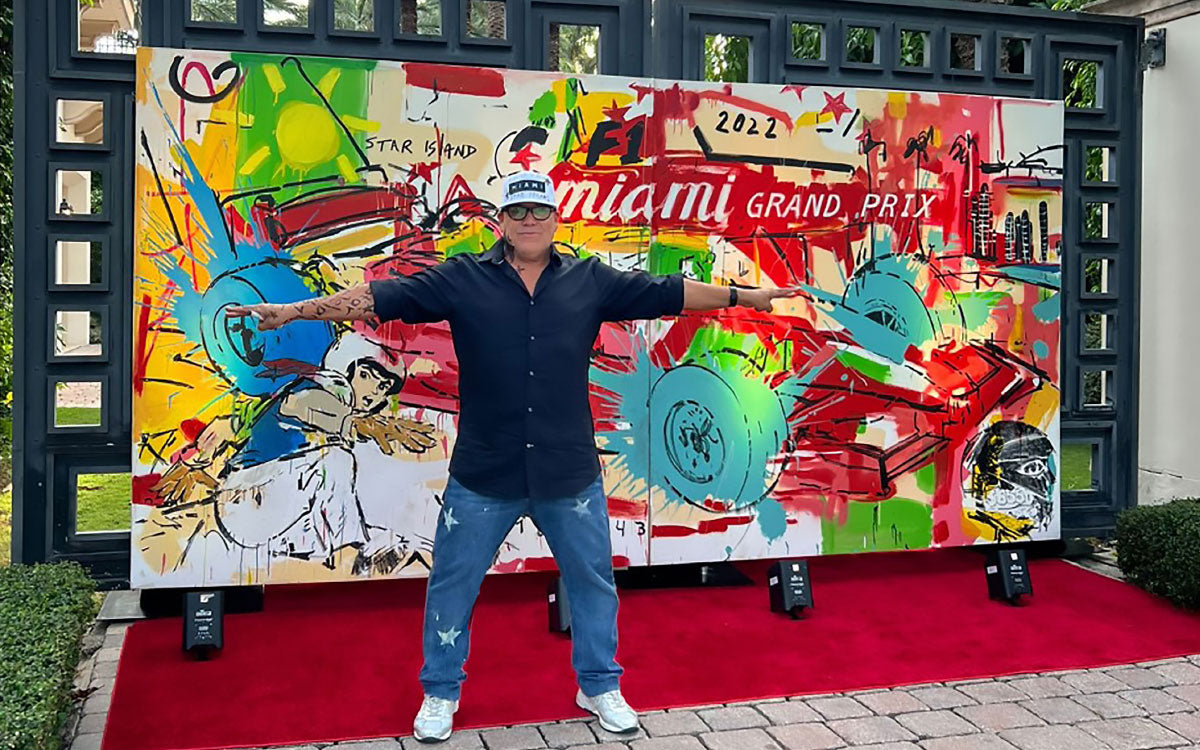 Leonardo Hidalgo posing in front of a small mural he painted for the Miami F1 Grand Prix.